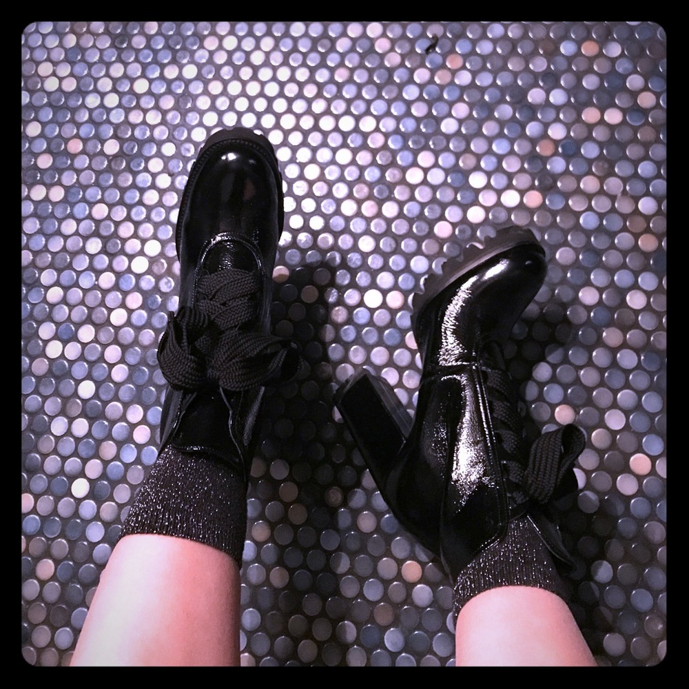 Black patent leather Minelli lace up boots.